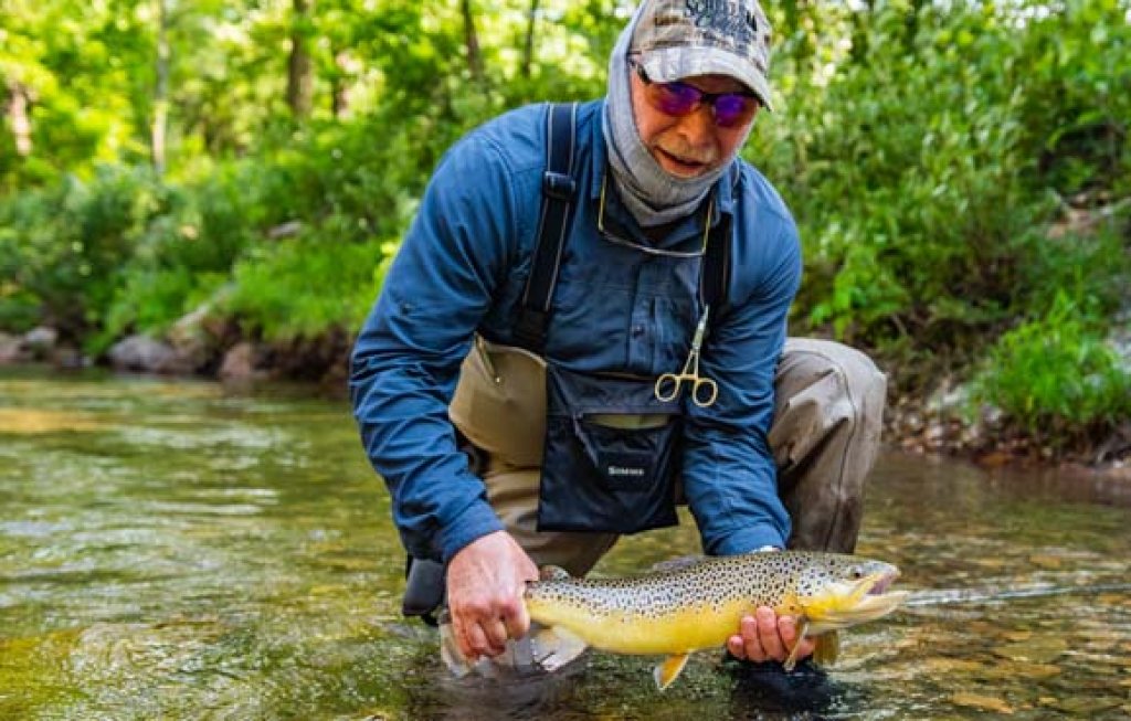 fisherman with brown trout.