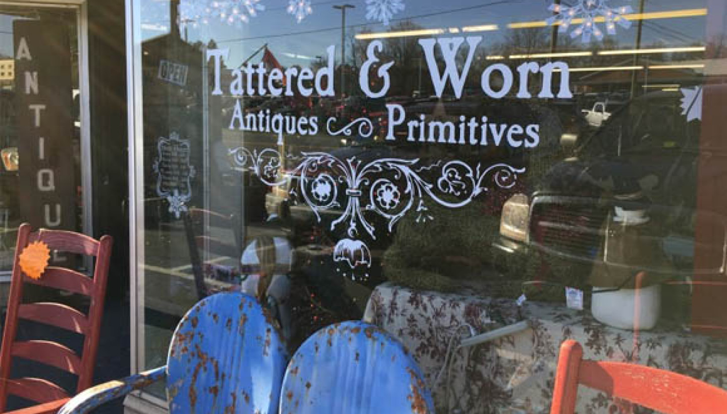 tattered & worn antique storefront window