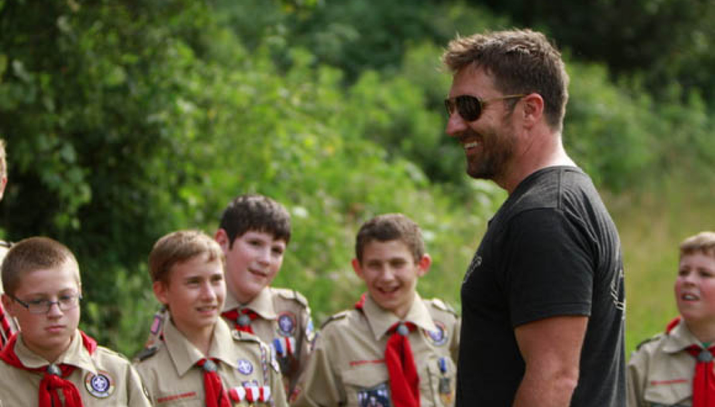 Man with boys in uniforms