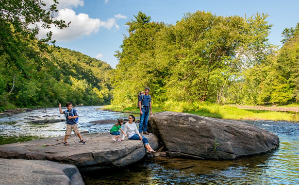 People on rocks at Greenbrier River Trail.