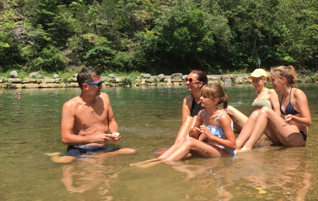 Family in shallow creek.