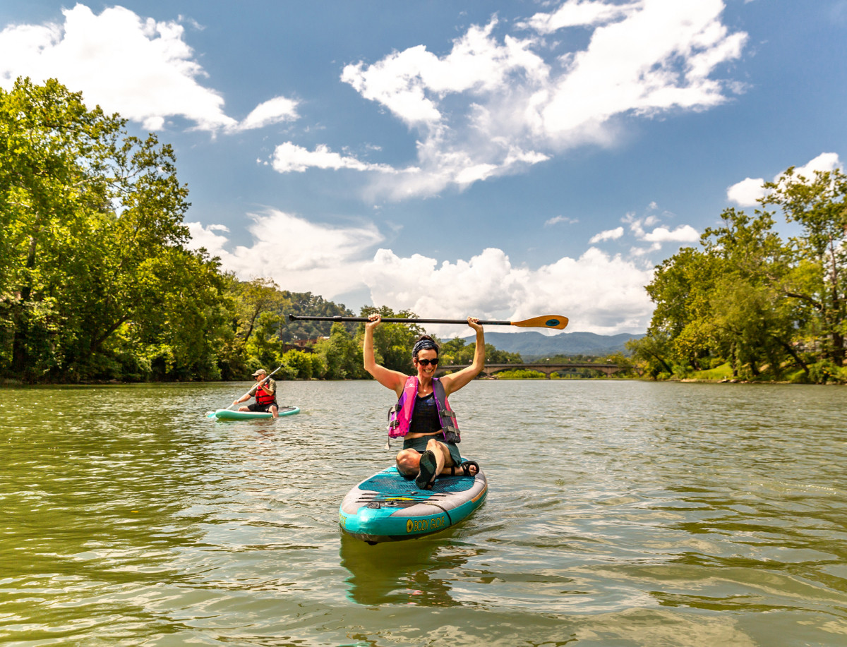 Paddle boarding down river