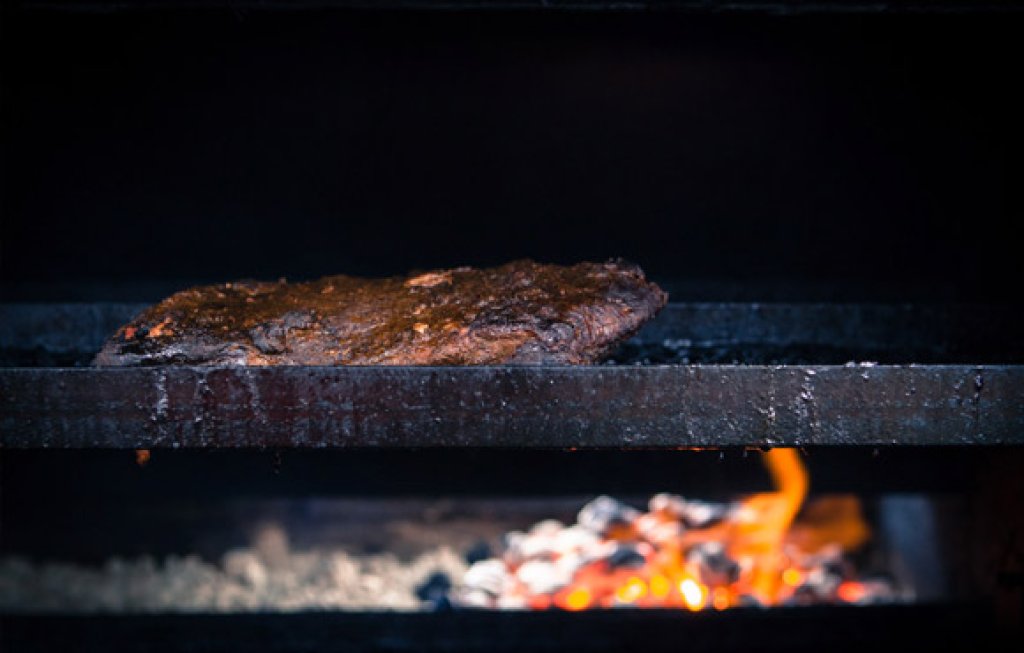 BBQ being cooked over open flame.