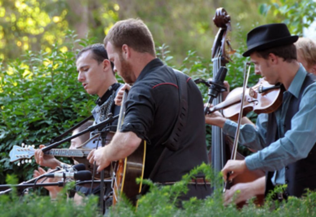 Four piece band playing instruments.