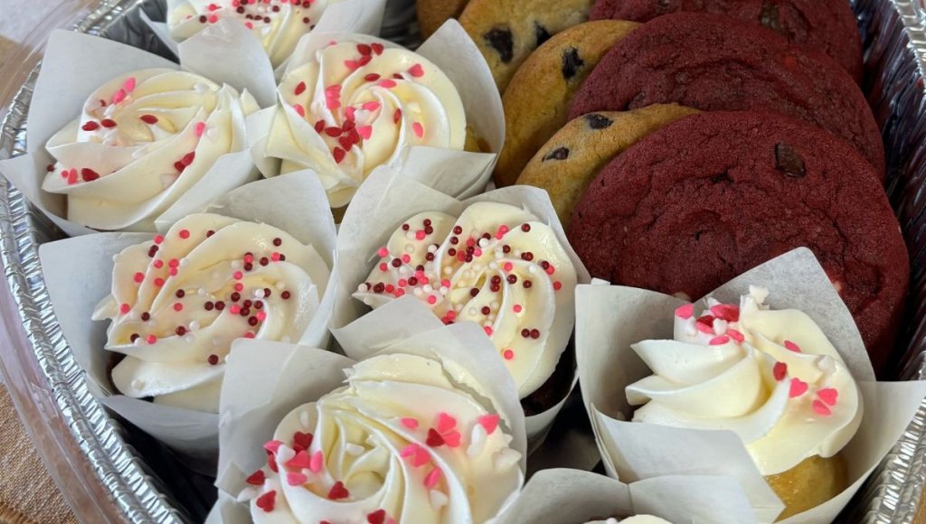 tootsies place cookies and cupcakes in a platter.